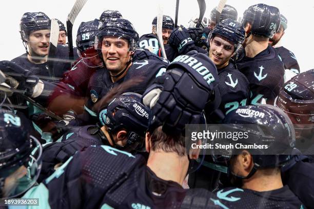 The Seattle Kraken bombard Justin Schultz after his game-winning goal in overtime against Carter Hart of the Philadelphia Flyers at Climate Pledge...