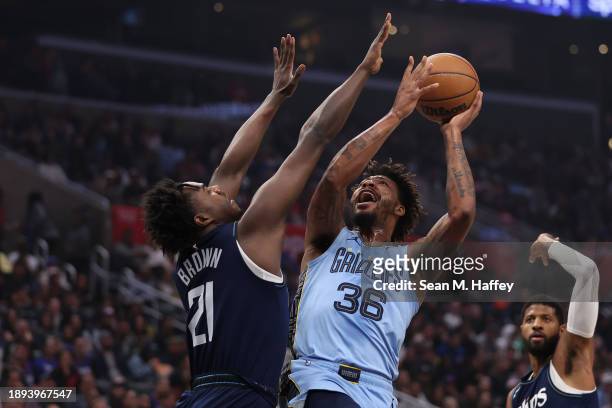 Marcus Smart of the Memphis Grizzlies shoots past the defense of Kobe Brown of the LA Clippers during the first half of a game at Crypto.com Arena on...