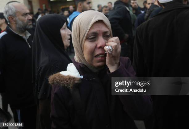 Woman relative of the Matar family killed in Israeli attacks as they take their bodies from the morgue of Al-Aqsa Martyr's Hospital for burial as...