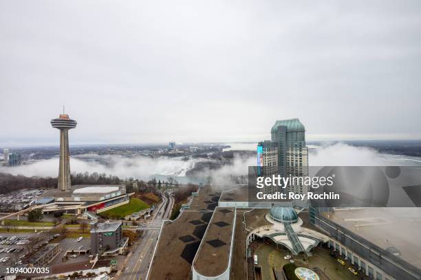 View of the Skylon Tower with the American Falls and the Fallsview Casino Resort as a mist covers the Horseshoe Falls on the right side of the image...