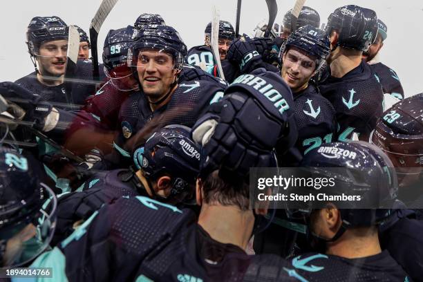 The Seattle Kraken bombard Justin Schultz after his game-winning goal in overtime against Carter Hart of the Philadelphia Flyers at Climate Pledge...