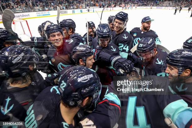 The Seattle Kraken bombard Justin Schultz after his game-winning goal in overtime against Carter Hart of the Philadelphia Flyers at Climate Pledge...