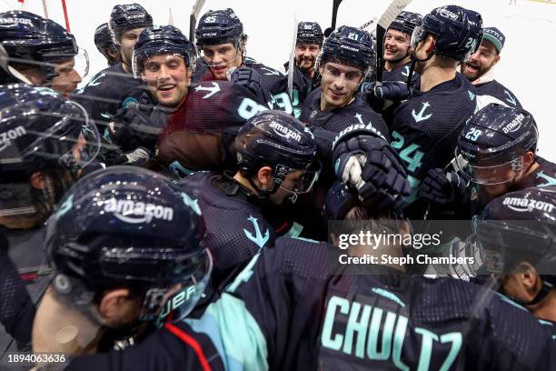 The Seattle Kraken bombard Justin Schultz after his game-winning goal in overtime against Carter Hart of the Philadelphia Flyers at Climate Pledge...