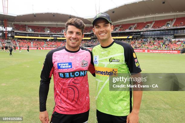 Moises Henriques of the Sixers and Chris Green of the Thunder pose for a photo after the batflip during the BBL match between Sydney Thunder and...