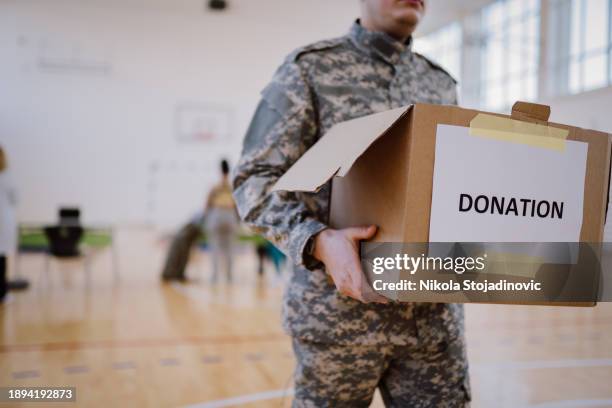 a soldier and donation box - man holding donation box stock pictures, royalty-free photos & images