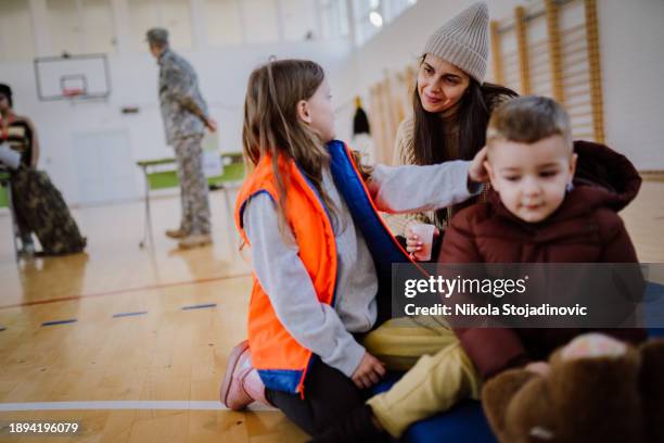 bénévole organiser un don - réfugiés et personnes déplacées photos et images de collection