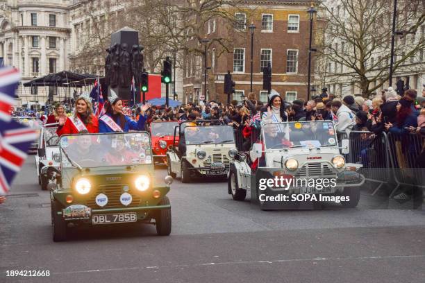 Mini Moke' vehicle enthusiasts and Miss Great Britain pass through Whitehall during London's New Year's Day Parade.