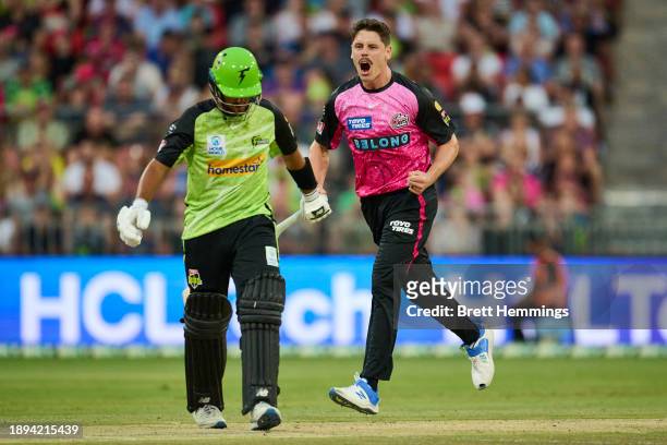 Ben Dwarshuis of the Sixers celebrates after taking the wicket of Ollie Davies of the Thunder during the BBL match between Sydney Thunder and Sydney...