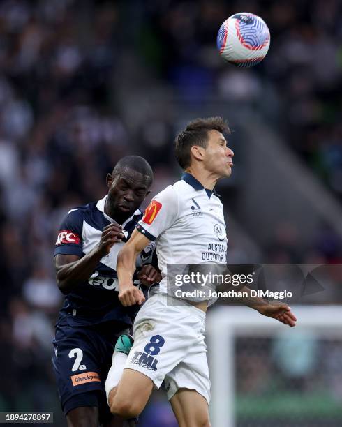 Jason Geria of Melbourne Victory and Isaias of Adelaide United contest for the ball during the A-League Men round 10 match between Melbourne Victory...