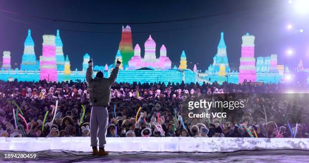 Tourists enjoy a musical performance at the 25th Harbin Ice and Snow World, one of the world's leading theme parks featuring large-scale ice and snow...