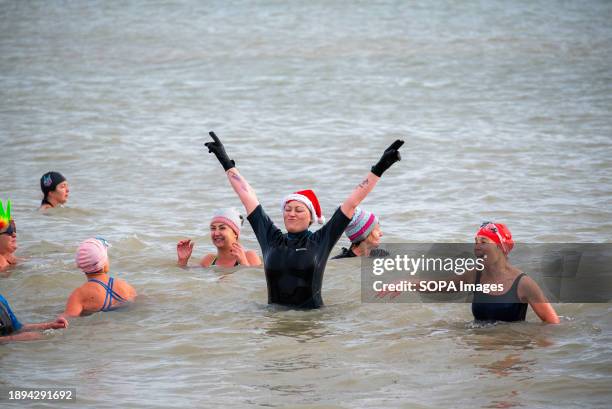 Woman with a Santa hat enjoys the cold water in Ramsgate. Three hundred residents and visitors gathered at the Main Sands of Ramsgate for the New...