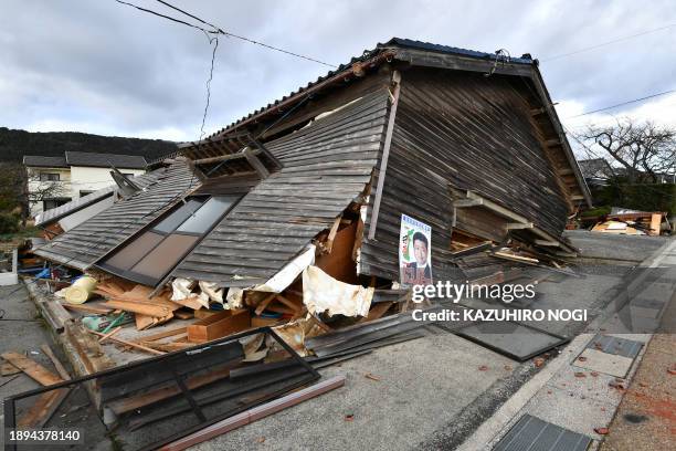Collapsed wooden house is seen in Wajima, Ishikawa prefecture on January 2 a day after a major 7.5 magnitude earthquake struck the Noto region in...