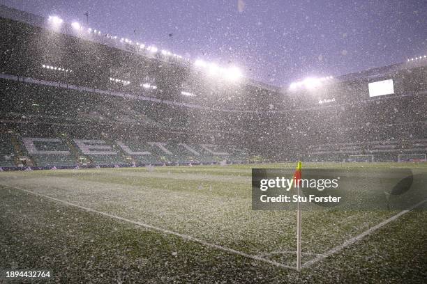 Snow falls on the pitch prior to the Cinch Scottish Premiership match between Celtic FC and Rangers FC at Celtic Park Stadium on December 30, 2023 in...