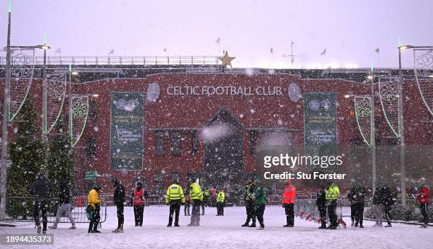 Snow falls outside the ground prior to the Cinch Scottish Premiership match between Celtic FC and Rangers FC at Celtic Park Stadium on December 30,...