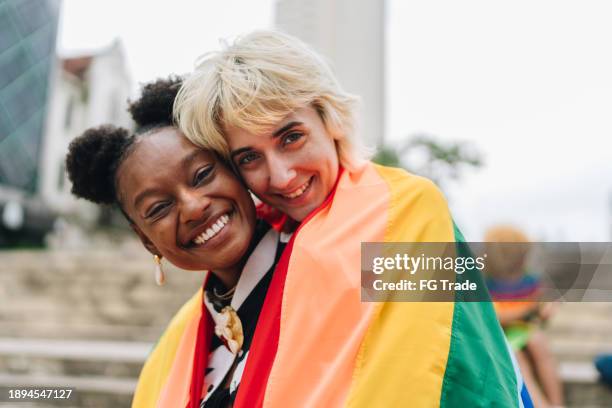 portrait of a lesbian couple embracing outdoors - black girlfriend pics stock pictures, royalty-free photos & images