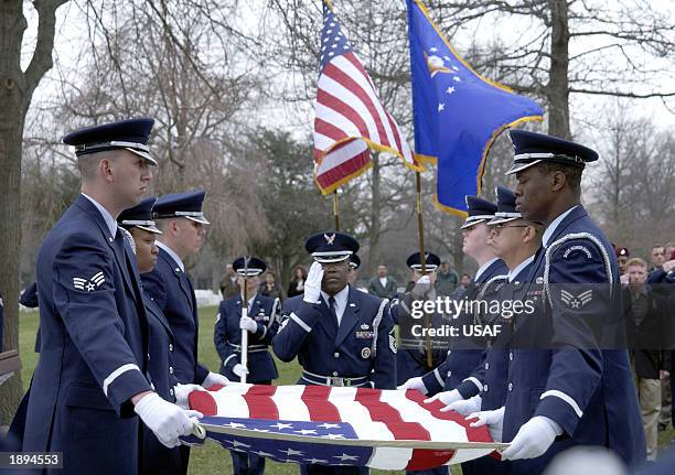 Honor Guard members of the 305th Air Mobility Wing of McGuire Air Force Base, New Jersey, remove a U.S. Flag from the casket of Master Sergeant...