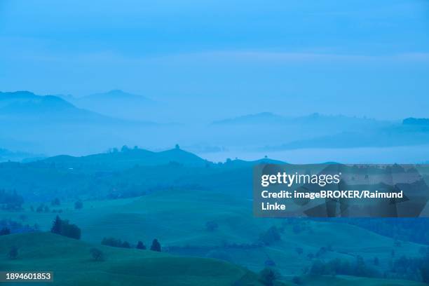 moraine hill landscape with meadows and trees and some farms with morning fog and cloudy sky, menzingen, prealps, zug, canton zug, switzerland, europe - menzingen stock pictures, royalty-free photos & images