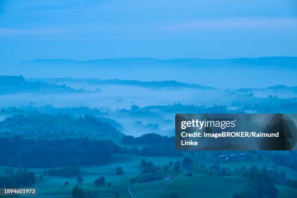 moraine hill landscape with meadows and trees and some farms with morning fog and cloudy sky, menzingen, prealps, zug, canton zug, switzerland, europe - menzingen stock pictures, royalty-free photos & images