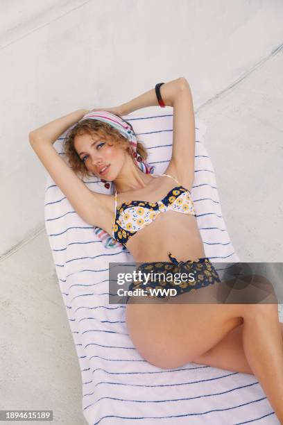 Shoshanna’s nylon and Lycra bikini. Echo scarf worn in hair; Miu Miu sunglasses; Tuza earrings, bracelet and ring...Swimsuit Trend 2020: Staycation...