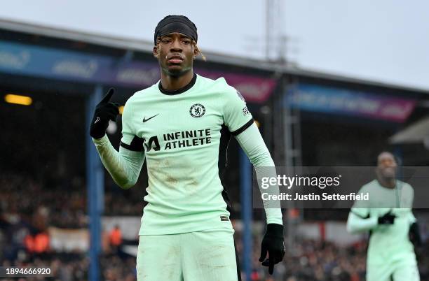 Noni Madueke of Chelsea celebrates after scoring their team's second goal during the Premier League match between Luton Town and Chelsea FC at...