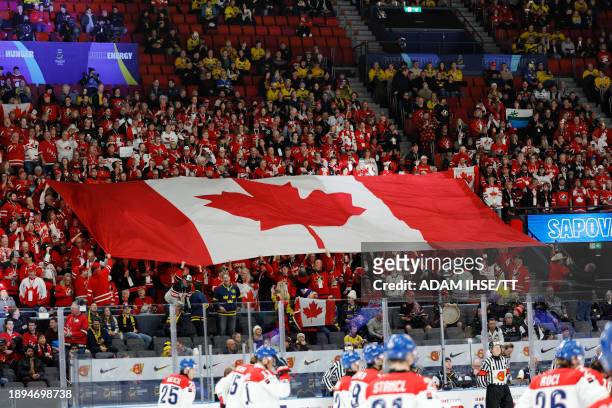 Canadian fans hold up their flag on the stands before the quarter-final match between Canada and Czech Republic of the IIHF World Junior Championship...