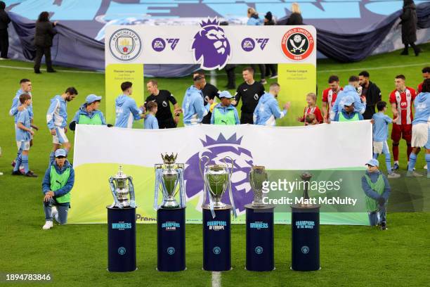 The Emirates FA Cup, English Premier League, UEFA Champions League, UEFA Super Cup and FIFA Club World Cup trophies are displayed as both sides enter...