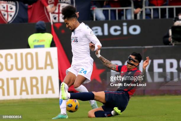 Gianluca Lapadula of Cagliari compete for the ball with Tyronne Ebuehi of Empoli during the Serie A TIM match between Cagliari Calcio and Empoli FC...