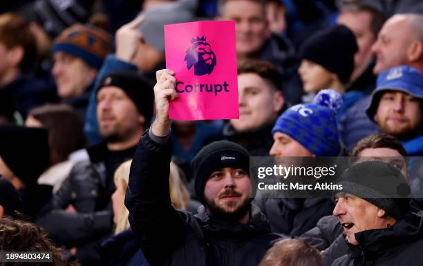 Everton fans hold up banners which read 'Premier League Corrupt' during the Premier League match between Wolverhampton Wanderers and Everton FC at...