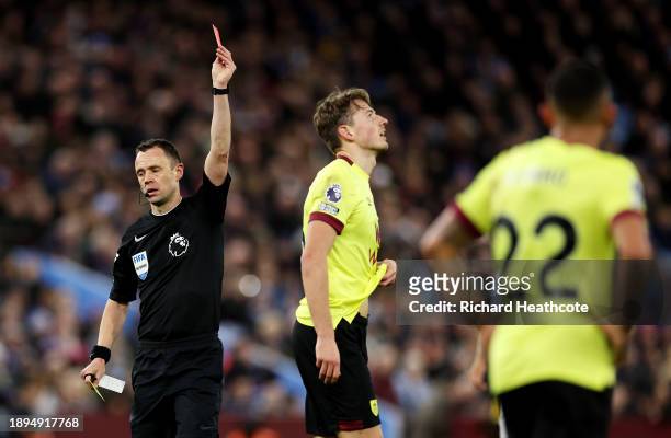 Sander Berge of Burnley is shown a red card by Referee Stuart Attwell during the Premier League match between Aston Villa and Burnley FC at Villa...