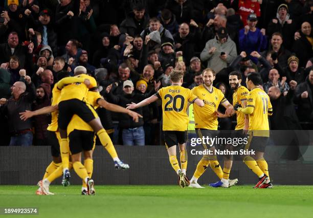 Craig Dawson of Wolverhampton Wanderers celebrates with team mates after scoring their sides third goal during the Premier League match between...