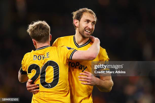 Craig Dawson of Wolverhampton Wanderers celebrates with team mate Tommy Doyle after scoring their sides third goal during the Premier League match...