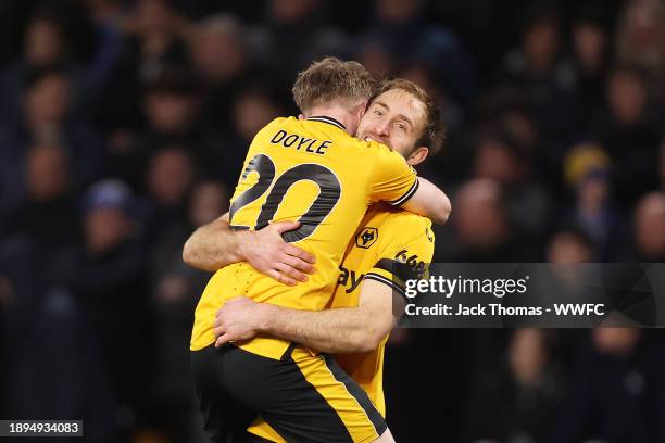 Craig Dawson of Wolverhampton Wanderers celebrates with team mate Tommy Doyle after scoring their sides third goal during the Premier League match...