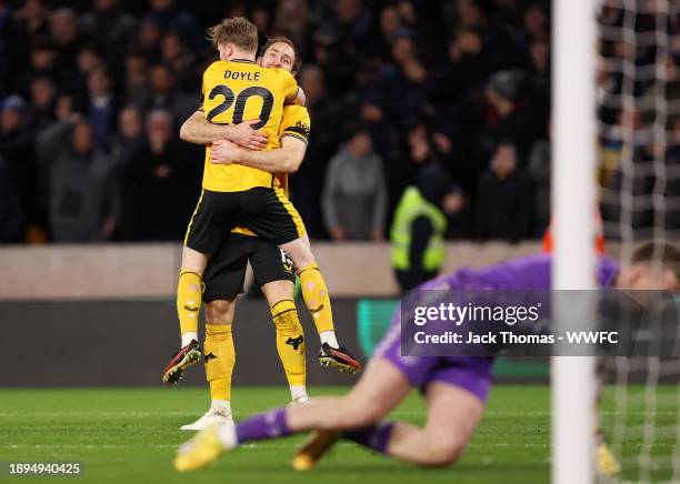 Craig Dawson of Wolverhampton Wanderers celebrates with teammate Tommy Doyle after scoring their team's third goal during the Premier League match...