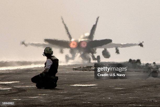 An F/A-18 Hornet from the ?Silver Eagles? of Marine Fighter Attack Squadron One Fifteen is put through routine maintenance on the flight deck of USS...