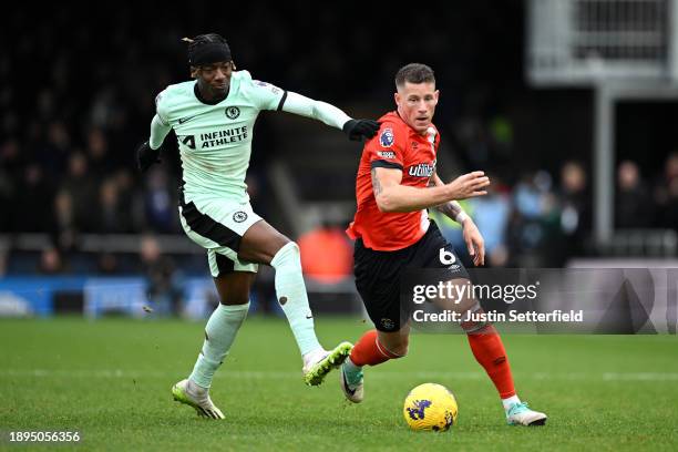 Noni Madueke of Chelsea battles for possession with Ross Barkley of Luton Town during the Premier League match between Luton Town and Chelsea FC at...