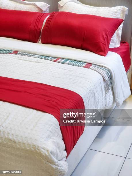 close-up of neatly made red and white bed - made up bed stock pictures, royalty-free photos & images