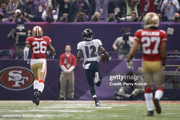 Jacoby Jones of the Baltimore Ravens returns a kickoff for a 108-yard touchdown against the San Francisco 49ers during Super Bowl XLVII at...