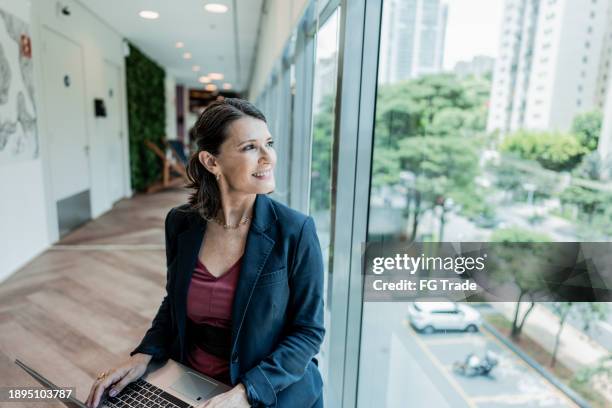 businesswoman contemplating on the office - anticipation stock pictures, royalty-free photos & images