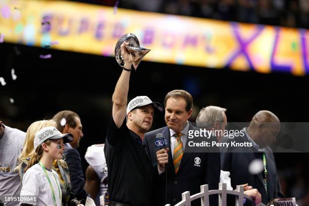 Baltimore Ravens head coach John Harbaugh holds up the Vince Lombardi Trophy after defeating the San Francisco 49ers during Super Bowl XLVII at...