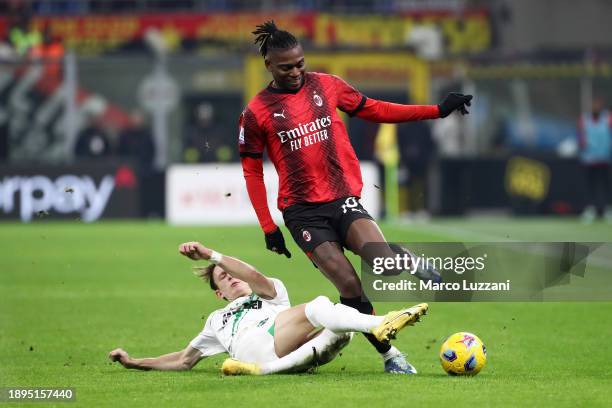 Rafael Leao of AC Milan is challenged by Marcus Holmgren Pedersen of US Sassuolo during the Serie A TIM match between AC Milan and US Sassuolo at...