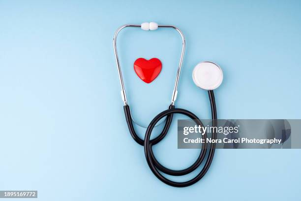 medical stethoscope and heart on blue background health care insurance concept - stetoskop bildbanksfoton och bilder