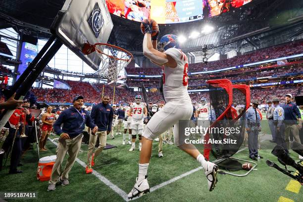 Caden Prieskorn of the Mississippi Rebels celebrates his touchdown against the Penn State Nittany Lions by dunking on a basketball hoop on the...