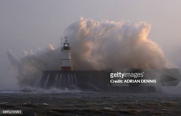 Waves crash over Newhaven Lighthouse and the breakwater in Newhaven on January 2 as Storm Henk brought strong winds and heavy rain across much of...