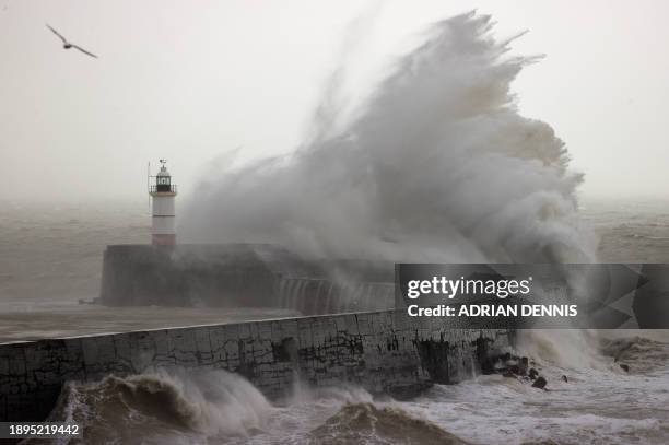 Waves crash over Newhaven Lighthouse and the breakwater in Newhaven on January 2 as Storm Henk brought strong winds and heavy rain across much of...