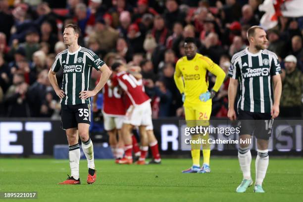 Jonny Evans of Manchester United looks dejected after Nicolas Dominguez of Nottingham Forest scores their sides first goal during the Premier League...