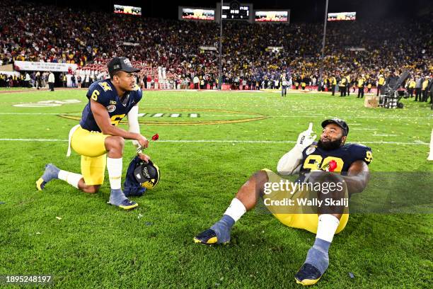 Michigan Wolverines wide receiver Cornelius Johnson and defensive lineman Cam Goode celebrate after defeating Alabama 27-20 in overtime of the...