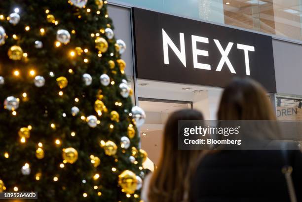 Christmas tree outside a Next Plc clothing store in Romford, UK, on Tuesday, Jan. 2, 2024. Next release Q4 sales figures on Jan. 4. Photographer:...