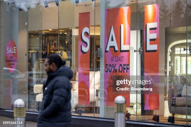 Promotional sales signs in the window of a Next Plc clothing store in Romford, UK, on Tuesday, Jan. 2, 2024. Next release Q4 sales figures on Jan. 4....