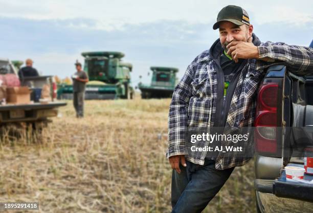 man standing by his pickup truck on farm during lunch break - agricultural equipment stock pictures, royalty-free photos & images