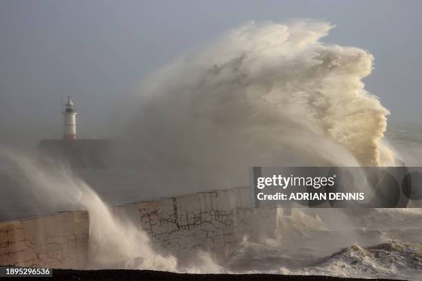 Waves crash over Newhaven Lighthouse and the breakwater in Newhaven on January 2 as Storm Henk brought strong winds and heavy rain across much of...